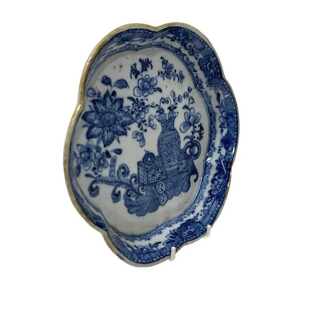 A Qianlong period Chinese blue and white porcelain Pattipan or tea stand with scalloped edge with faded gold rim en floral...