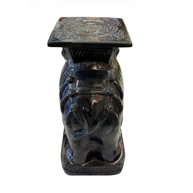 This striking ceramic elephant garden stool serves as a versatile statement piece, blending traditional symbolism with a...