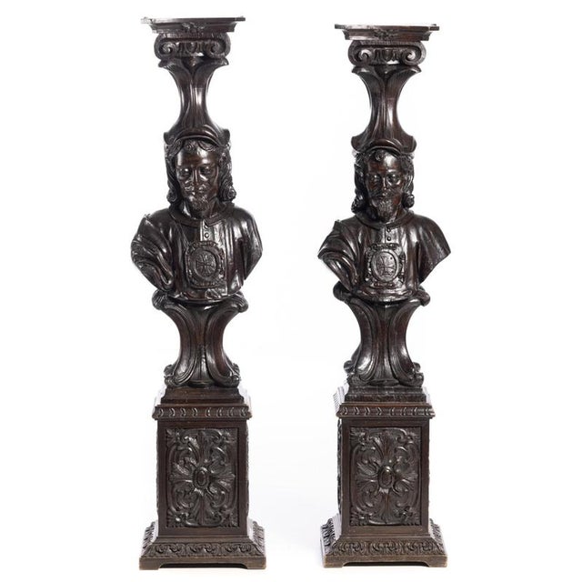 Pair of 19th-century columns made of chestnut wood with carvings, decorated with male figures holding templar crosses....