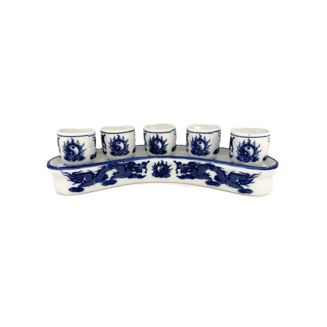 A striking six-piece ceramic shot set from Bat Trang, Vietnam, consisting of five individual shot cups and a coordinating...