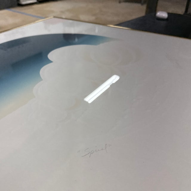 “Spiral” is a signed, embossed print by artist Edward Tompkins, known for his dimensional paper relief works and soft-...