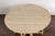 An English rustic pine drop leaf table from the 19th century with oval top, two drop leaves, carved apron, turned legs,...