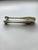 Sugar tongs by Christofle in the Rubans pattern, with a ribbon and bow motif on each arm, French Louis XVI–style...