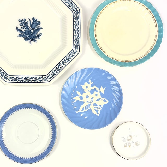 This hand-curated, 13-piece vintage blue and white mismatched china plate set is perfectly balanced and ready to hang....