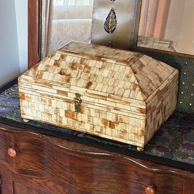 This large-scale Hollywood Regency style tessellated horn and bone inlay vanity chest is a stunning statement piece....