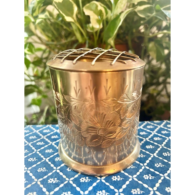 This vintage Indian brass flower frog dates to approximately the 1960s–1970s. This petite flower arranger features a...