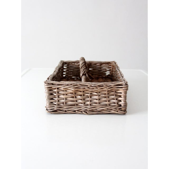 This vintage divided wicker basket brings a warm collected texture to a kitchen counter, dining table, or pantry shelf....