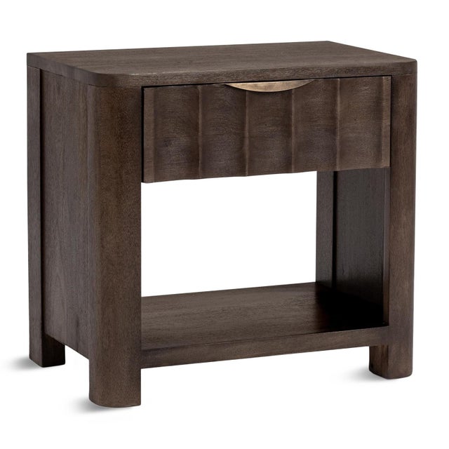 Handsome coco brown mango wood nightstand. One drawer with carved fluted design, and open shelving space below. Subtle...