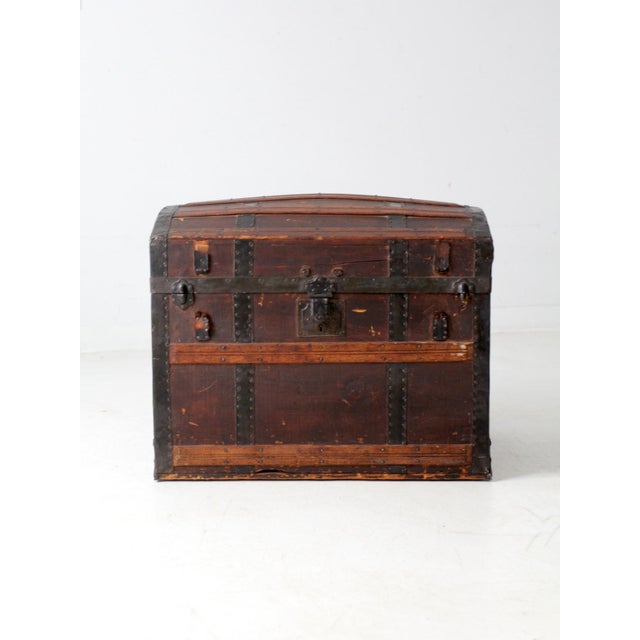 This 19th-century barrel top steamer trunk features a curved wooden dome lid framed with black metal hardware. It includes...