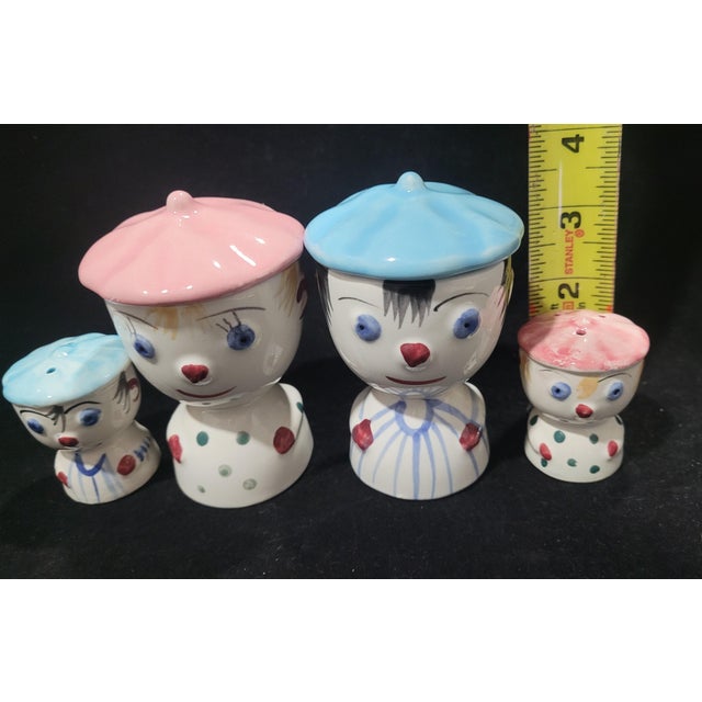 This adorable breakfast set includes: 2 egg cups / 1 boy & 1 girl with tops (hats) Pair matching of Salt & Pepper shakers...