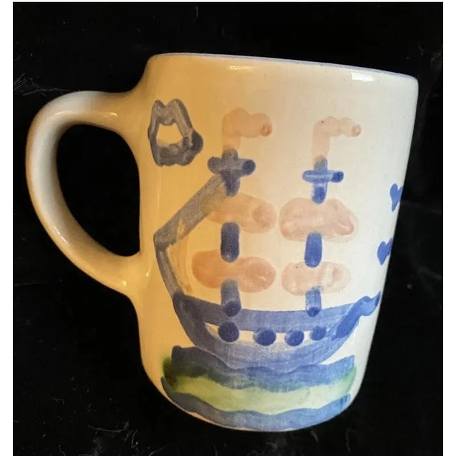 This vintage coffee mug by M A Hadley features a charming house and ship design, hand-painted in blue. The mug is a great...