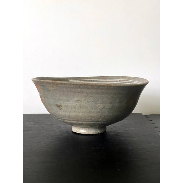 A Buncheong (also spelled as Punch'ong) stoneware tea bowl from Korea Joseon Dynasty circa 15-16th century. The conical...