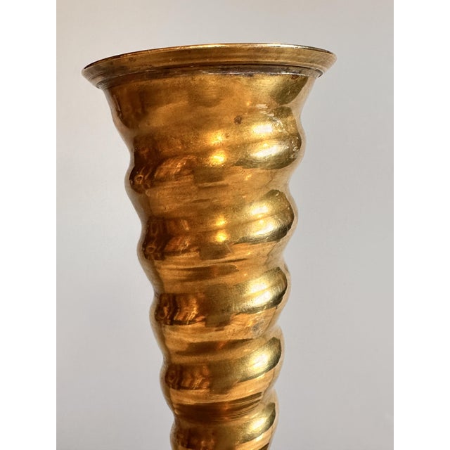 A decorative brass candlestick, crafted around 1900-1920 in a historicist style. The twisted column and the clearly...