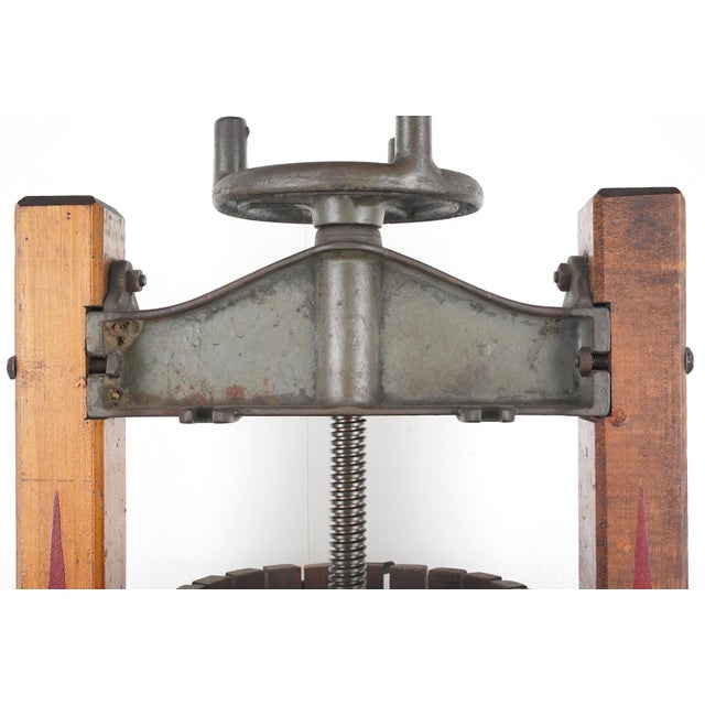 This antique fruit press used to make cider or wine. It features a hardwood stave barrel with metal bands to hold the...