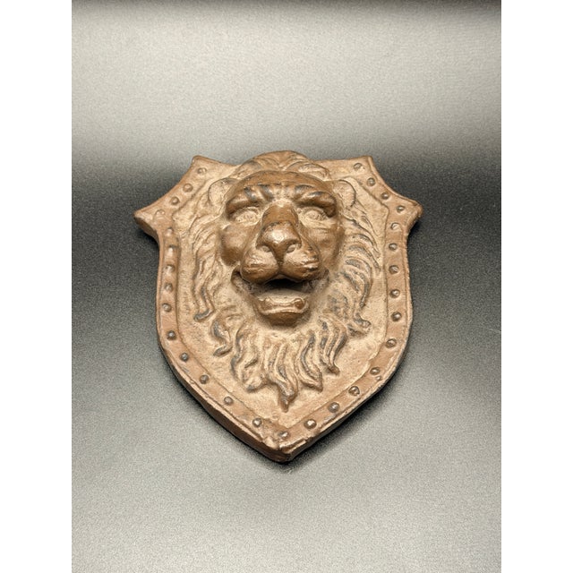 Bring bold character to any wall with this vintage cast iron lion head plaque, styled in a shield-shaped form with strong...