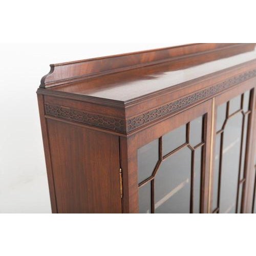A superb-quality mahogany glazed four-door side cabinet, combining elegant proportions with beautifully executed carved...