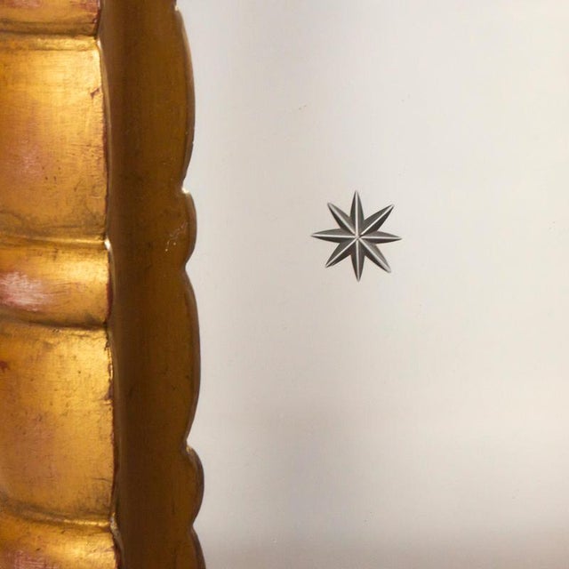 A 1950s, italian mirror with gilt wood frame and inner carved gilt wood frame. Delicate star detailing to mirror panels....