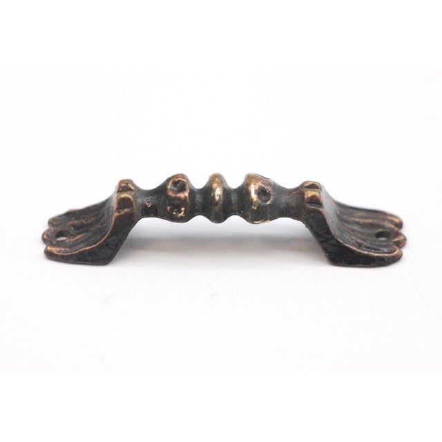 Extra small brass cabinet bridge pull with a black and antique brass patina. The original mounting screws are not...