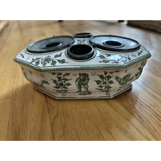 An Italian Faience and Pewter Inkwell, octagonal in shape with stylized raised lion heads on either end and decorated all...