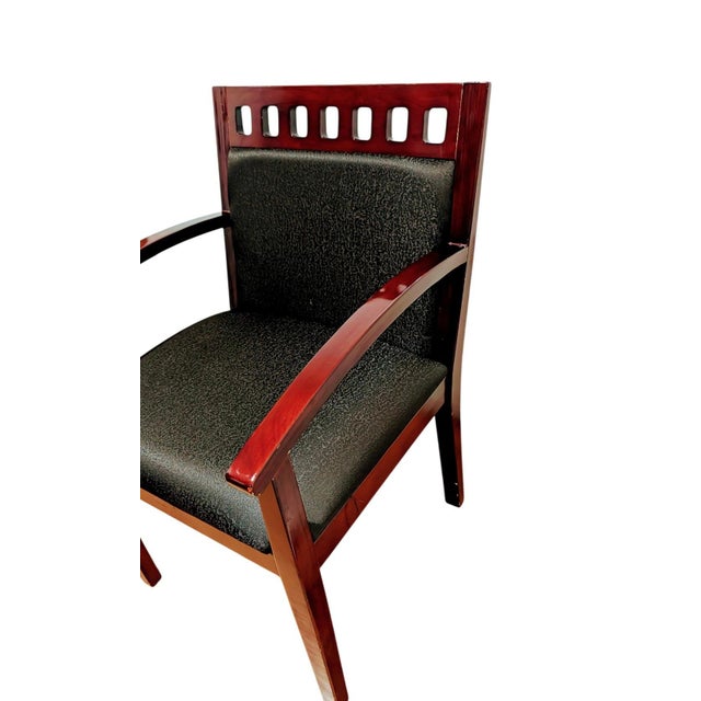 This is a beautiful wooden guest or office chair featuring a rich dark mahogany finish and a distinctive slotted cut-out...