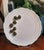 this trompe l’oeil plate is topped with seven sculpted ceramic olives that appear to rest directly on the surface. Rooted...