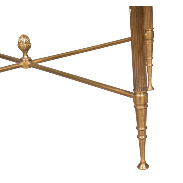 Three graduating glass top tables. The smallest with X form stretchers.