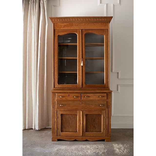 This stunning two-piece stepback cabinet beautifully balances rustic country warmth with refined French architectural...