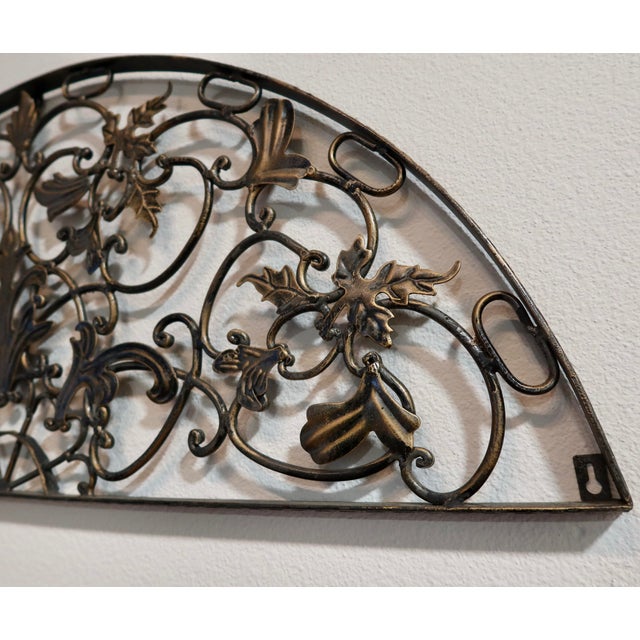 A substantial demilune (half-round) wall grille in the Rococo Revival style, featuring scrolling acanthus leaves, floral...