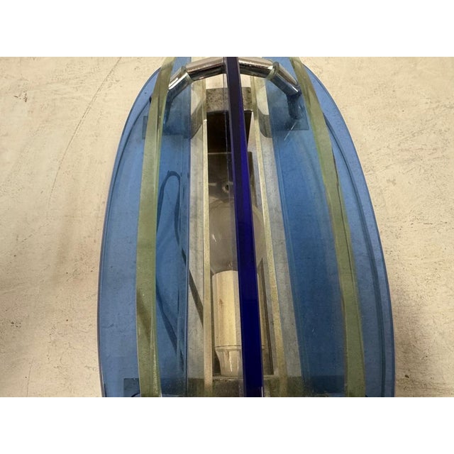 A pair of mid century Italian wall lamps by Veca, distinguished by their bold, sculptural use of coloured glass and...