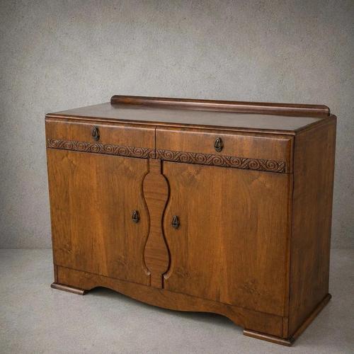 An elegant 1930s Art Deco sideboard and drinks cabinet in richly figured walnut, with a raised gallery back and...