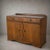 An elegant 1930s Art Deco sideboard and drinks cabinet in richly figured walnut, with a raised gallery back and...