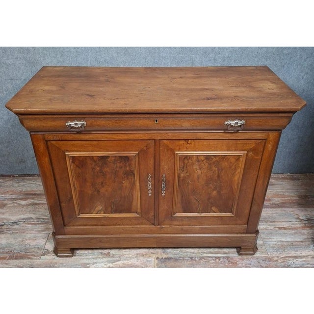 Louis-philippe period buffet in solid walnut, 19th century. an elegant storage unit with clean, balanced lines, opening at...
