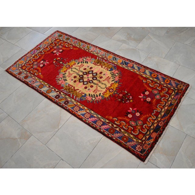 Offered a Turkish vintage area rug. Made in Anatolia approximately 50 years ago. The wool on cotton pile rug features...