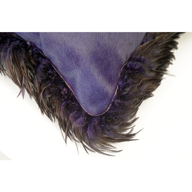 Made in America, this pillow made with a dyed Brazilian cowhide bordered with dyed feathers. It's back is a matching...