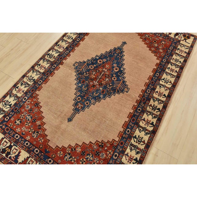 An authentic vintage tribal Gabbeh rug hand-knotted with fine wool and natural dyes. This nomadic rug features a central...