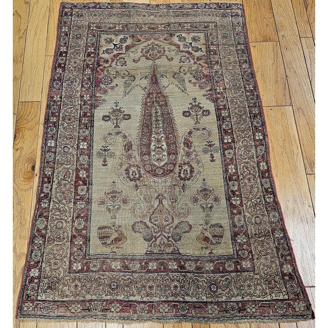 "An exquisite 19th-century Persian Kerman Lavar pictorial rug, masterfully handwoven in the late 1800s, featuring the...