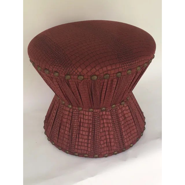 Ruben De Saavedra designed hourglass stool with oxblood red and black leather-embossed cotton upholstery and brass...