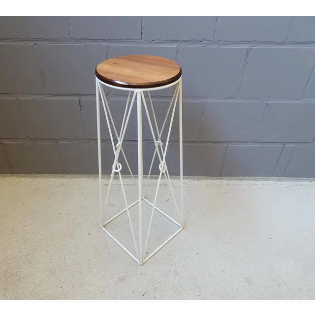 Large plant stand from the 1960s. A stylish plant column made of white lacquered iron and an applied wooden plate....