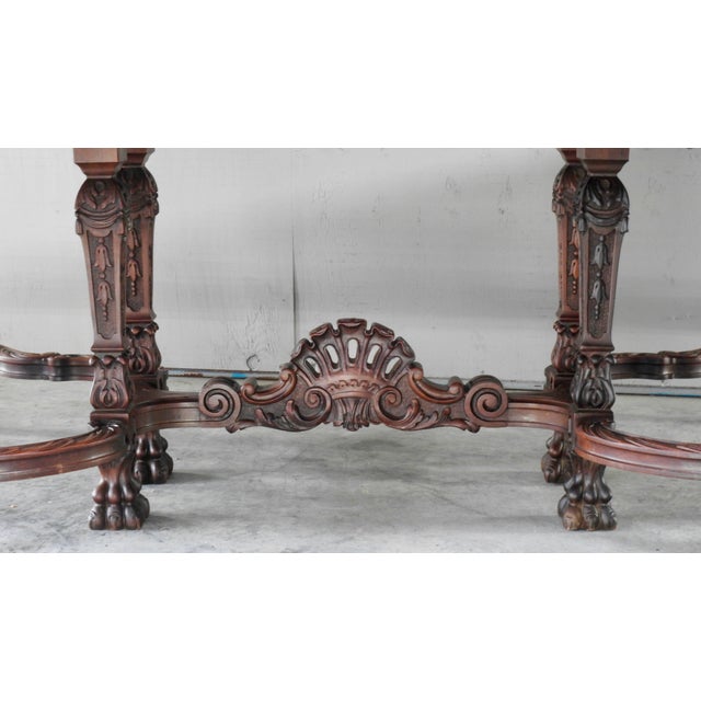 The details on this Victorian walnut dining table are exquisite! The draped carved legs have an ornate fan gracing the...