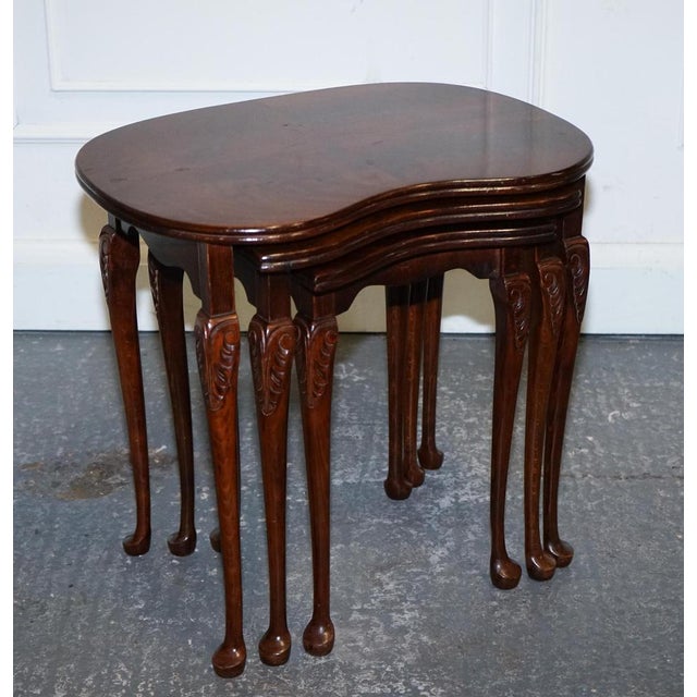 Vintage Kidney-shaped Nest Of Three Tables. They showcases exquisite craftsmanship and timeless elegance, crafted from...