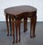 Vintage Kidney-shaped Nest Of Three Tables. They showcases exquisite craftsmanship and timeless elegance, crafted from...
