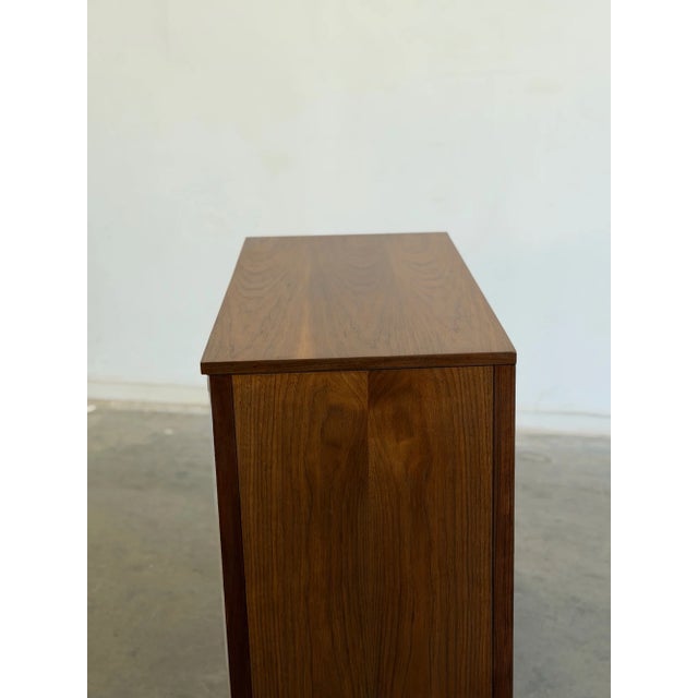 W36 D18 H34 This four drawer dresser by Paul McCobb for Calvin Furniture features rich grained walnut throughout and...