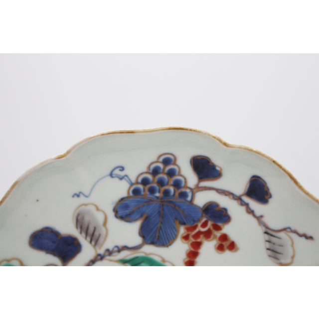 Late 18th-early 19th century lobed Arita plate, Japan. Decorated with grape clusters, vines & a butterfly. 8.25" dia. x 1...
