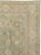 This early 20th-century Persian Tabriz carpet presents a refined allover floral composition across a soft blue-green...