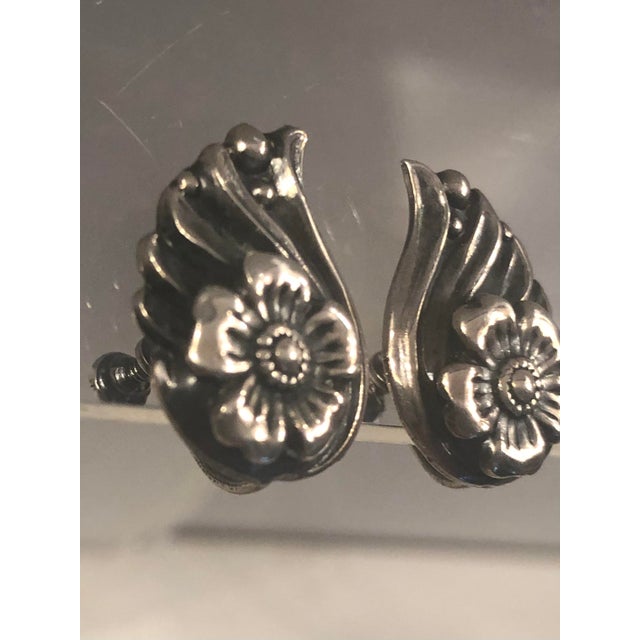 These lovely 1940s Sterling Repoussé Flower and Leaf Earrings will be a fabulous addition to any vintage jewelry...