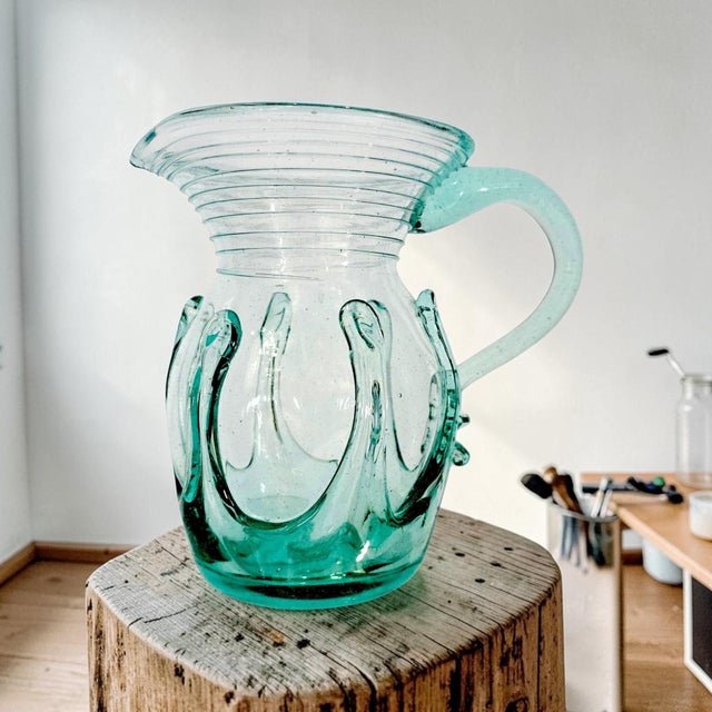 This Liberty Village Glasshouse lily pad pitcher was hand-blown in Liberty Village, New Jersey, in 1976. Executed in free-...