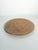 Decorative round ceramic dish in a warm brown glaze, featuring a finely molded bird perched on a flowering branch...