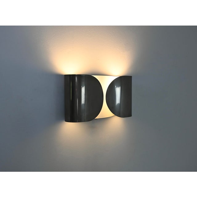 Chrome-plated metal wall lights designed by Afra & Tobia Scarpa. Model: Foglio. Stamped Flos. Wear consistent with age and...