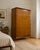A stylish mid-century walnut wardrobe by Alfred Cox, featuring beautifully figured ripple walnut veneers, tapered legs and...