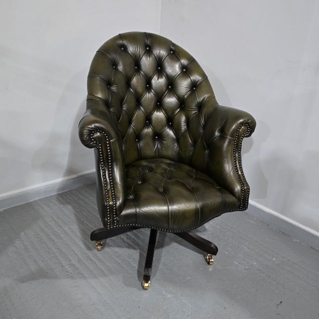 A super deep buttoned desk or office chair, swivel mechanism on brass castors, individual black studs, very good ovverall...